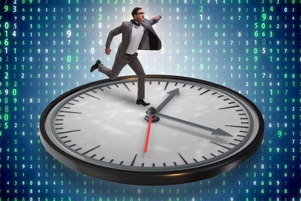 Businessman running on big clock in front of digital numerical code – symbol of time management and digital efficiency