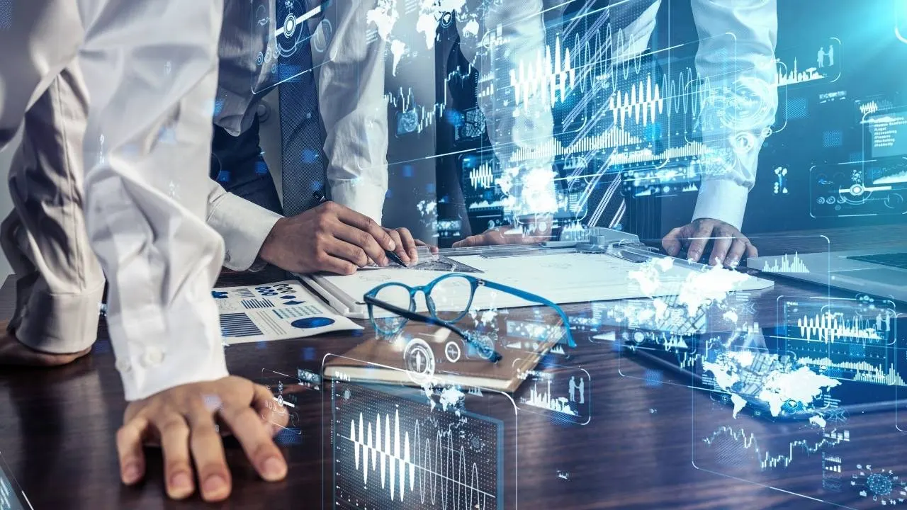Engineering team works together at one desk on new innovations. Co-creation promotes creative solutions and innovation in the team. The focus is on teamwork, the innovation process and creative collaboration.